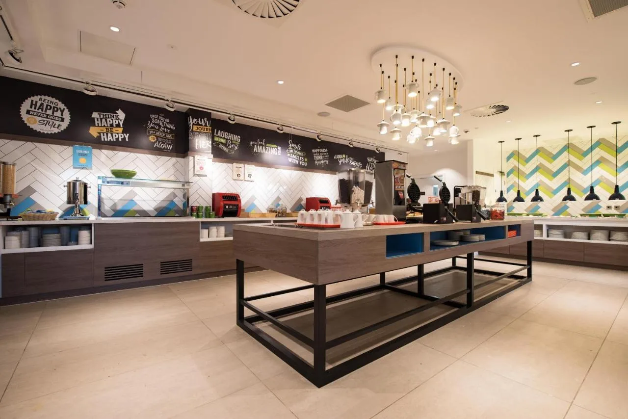 A restaurant with a central counter at Hampton by Hilton Edinburgh West End