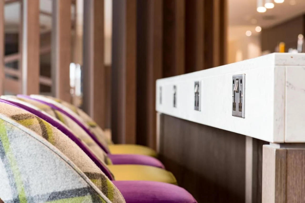 A row of purple and yellow chairs at Hampton by Hilton Edinburgh West End