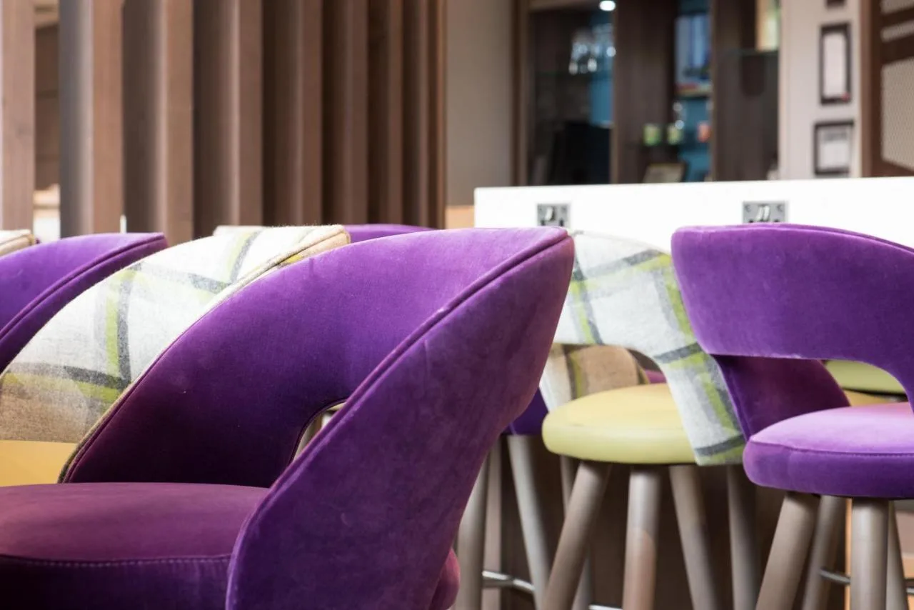 A group of purple chairs around a table at Hampton by Hilton Edinburgh West End